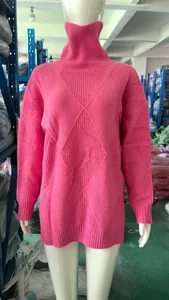 Close-up of pink oversized turtleneck sweater with diamond-knit pattern on mannequin