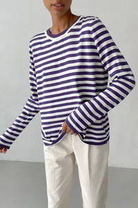 Detailed view of a purple and white horizontal striped crew neck knit sweater for women