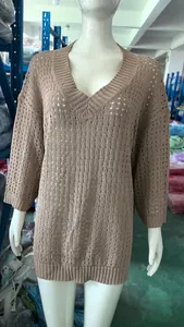 Beige hollow-out V-neck long sleeve knit sweater on a mannequin in a warehouse setting