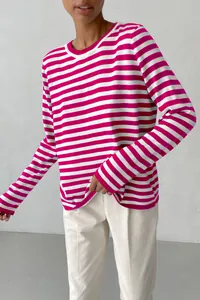 Detail of a vibrant pink and white striped knit sweater for women, round neck style