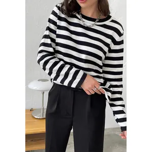 Detail view of a classic black and white striped knitted sweater with round neckline