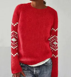 Vista dettagliata di un maglione rosso a girocollo con motivi geometrici bianchi.