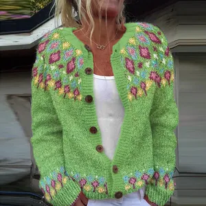 Detailed view of women's loose green knitted cardigan with vibrant colorful patterns