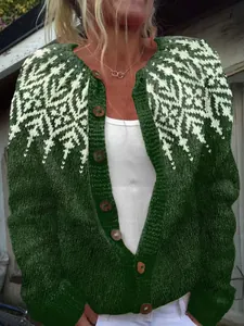 Detailed view of women's dark green knit cardigan with white Nordic snowflake pattern