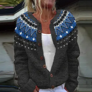 Close-up of women's chunky knit cardigan with blue geometric tribal pattern yoke