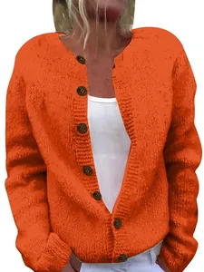Close-up of the vibrant orange chunky knit texture and brown decorative buttons on cardigan