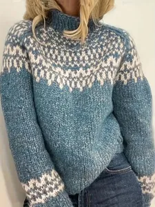 Close-up of blue and white Fair Isle knit pattern on a cozy turtleneck sweater.