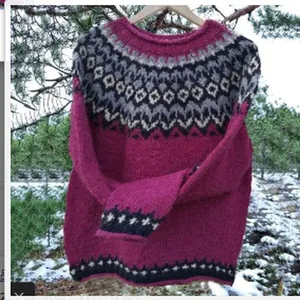 Detailed view of women's Fair Isle pattern knitted sweater in an outdoor winter setting