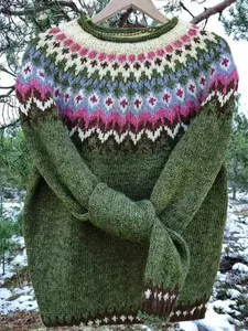 Detailed close-up of the Fair Isle yoke pattern on a green knitted round neck sweater