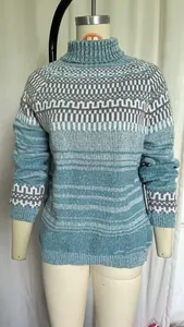 Close-up view of the women's high-neck knit sweater featuring blue geometric patterns.