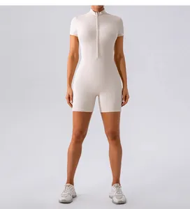 Front view detail of a women's half-zip athletic short-sleeved yoga romper in cream