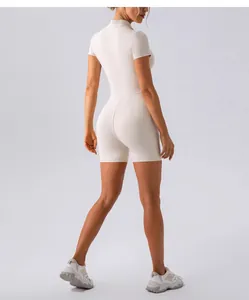 Back view of a slim fit beige yoga bodysuit with short sleeves and naked-feel fabric.