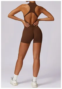 Detail showing the backless design and ruched seam of the brown athletic yoga romper.