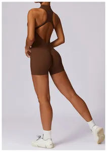 Detail view of brown athletic romper with ruched back and cross straps for yoga