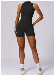 Professional full-length front view of a black sleeveless yoga romper with front zipper
