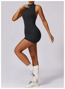 Women's zip-up yoga jumpsuit romper in matte black, showing the slim fit side profile.