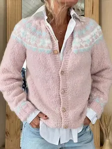 Close-up of a cozy women's pink knit cardigan with a blue patterned yoke design