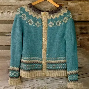Detailed view of women's vintage Nordic knitted cardigan with teal and beige patterns