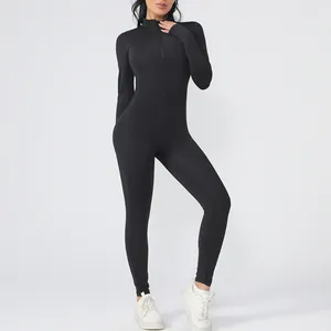 Women's sleek black long sleeve yoga jumpsuit with a front zipper for fitness and workout