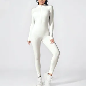 Detailed view of women's white long-sleeved one-piece yoga jumpsuit with zipper