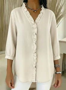Close-up of the elegant ruffle trim on this beige faux denim V-neck shirt for women