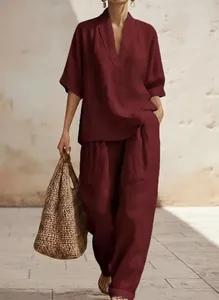Detailed look of elegant maroon linen V-neck short sleeve top and wide leg trousers set