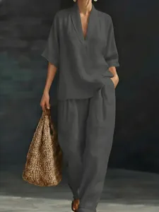 Elegant grey V-neck short sleeve top and loose wide-leg trousers set for summer fashion