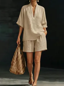 Detailed shot of a stylish beige V-neck linen set including loose shorts and a top