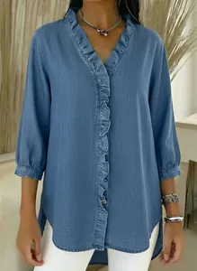 Close-up detail of casual blue V-neck denim shirt with ruffle trim and 3/4 sleeves.