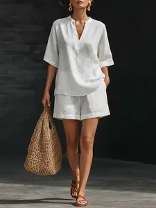 Close-up of white V-neck linen set with loose short sleeve top and wide leg shorts