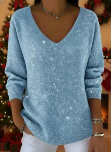 Detail view of light blue V-neck top with sparkling glitter texture and festive theme