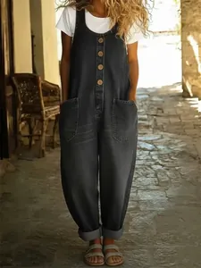 Retro dark gray denim-style wide-leg jumpsuit worn by a model in an alley