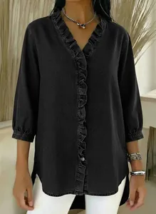 Close-up of women's black faux denim V-neck shirt featuring elegant ruffle trim.
