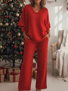 Festive red glitter two-piece lounge set featuring a V-neck top and wide-leg trousers