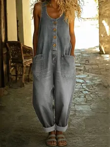 Full view of a vintage grey sleeveless denim jumpsuit with wide legs and front buttons