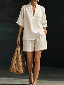 Model wearing minimalist cream linen-blend V-neck top and matching shorts set detail