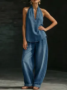 Detail view of Western style denim halter top and wide-leg trousers set in vintage blue