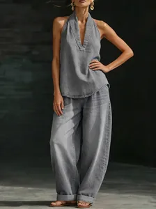 Grey denim two-piece set featuring a halter V-neck top and wide-leg trousers detail