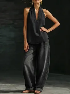 Full view of stylish retro dark wash denim set with halter v-neck top and wide-leg pants