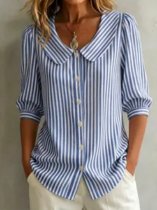 Detail of blue striped cotton linen blouse with Peter Pan collar and puff sleeves.