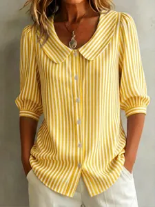 Close-up of yellow and white striped blouse featuring a Peter Pan collar and button-down