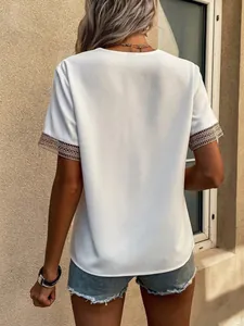 Back view of white short sleeve blouse with delicate lace trim cuffs and casual fit