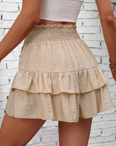 Detailed view of the tiered ruffle design and smocked waist on the beige casual skort.