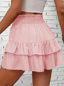 Detailed view of the layered ruffles on this elegant pink high-waisted skort for women.