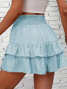 Back view of a light blue tiered ruffled mini skort featuring an elastic high waist.