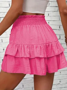 Rear view detail of a bright pink tiered ruffle summer skort with an elastic waist design