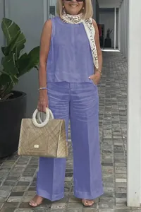 Full-length detail of a blue linen-style sleeveless top and wide-leg trousers on model.