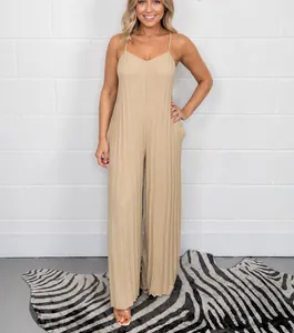 Elegant beige pleated wide-leg jumpsuit with spaghetti straps and V-neckline
