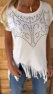 Detailed view of white short sleeve T-shirt with rhinestone pattern and fringe hem