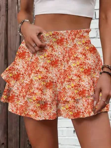 Detail view of stylish floral ruffle shorts with elastic high waist and tiered design